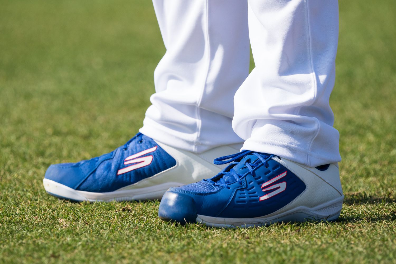 View of Los Angeles Dodgers pitcher Clayton Kershaw's blue and white Skechers cleats.
